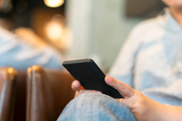 istock girl reading on mobile phone in cafe 692459278