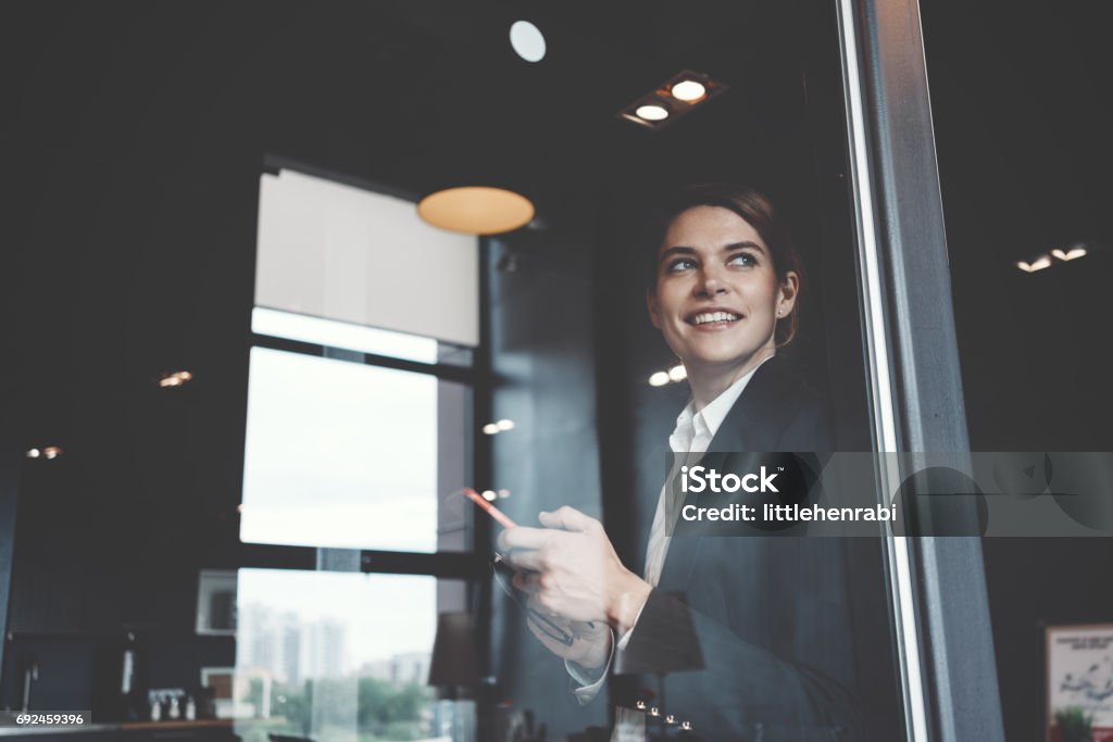 Portrait of charming business lady in office Portrait of charming business lady working in big open space office Teamwork Stock Photo