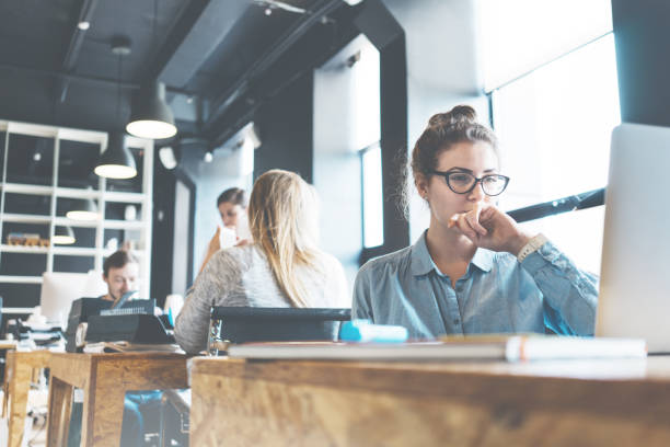 Portrait of handsome business lady at workplace stock photo