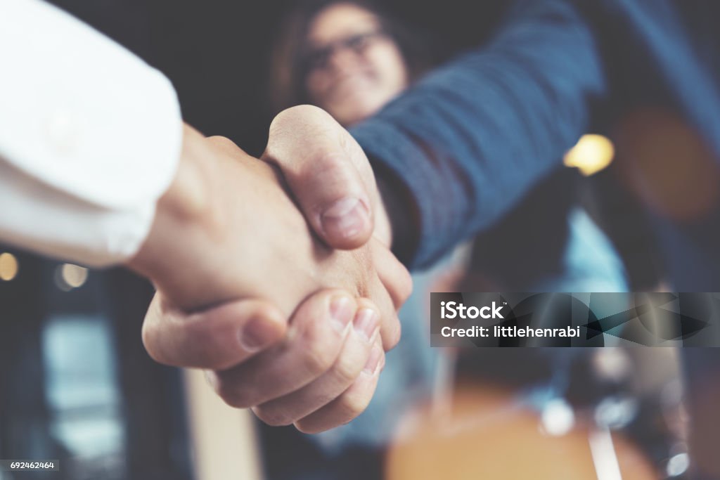 Business people shaking hands Business people shaking hands in the office after succesful meeting. Three persons Handshake Stock Photo