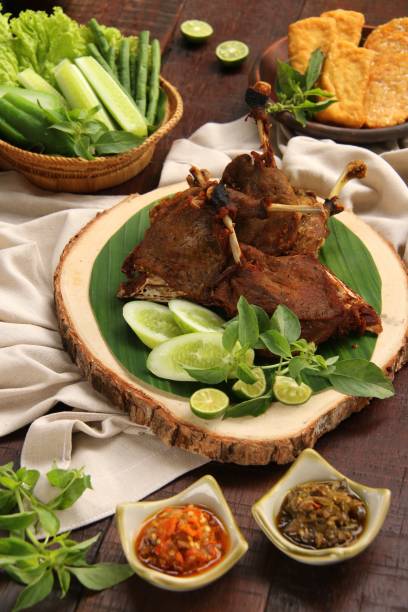 istock Bebek Goreng, Indonesian Fried Duck Dish with Green Vegetables and Chili Paste 692462524