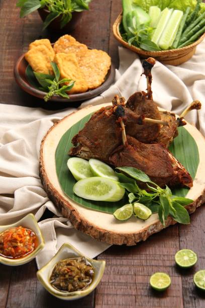 istock Bebek Goreng, Indonesian Fried Duck Dish with Green Vegetables and Chili Paste 692462526