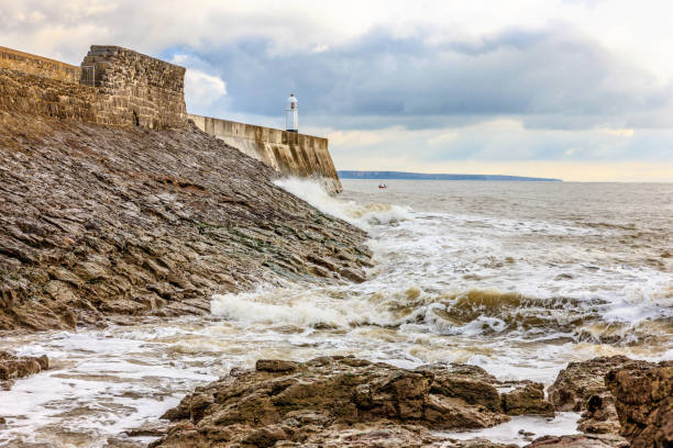 Porthcawl lighthouse and coastline. A small boat is approaching