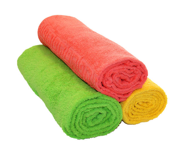 istock Yellow, green and red rolled up  towels isolated 692465544