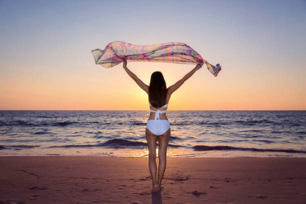 istock Woman relaxing on the beach 692465726