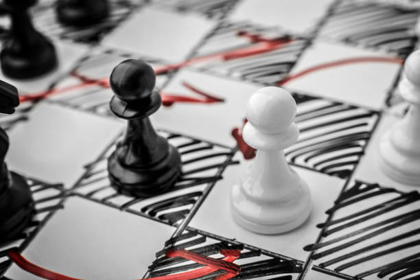 istock Chess. White and Black pawn facing each other on a white board. Pawns, infantry chess. 692473272