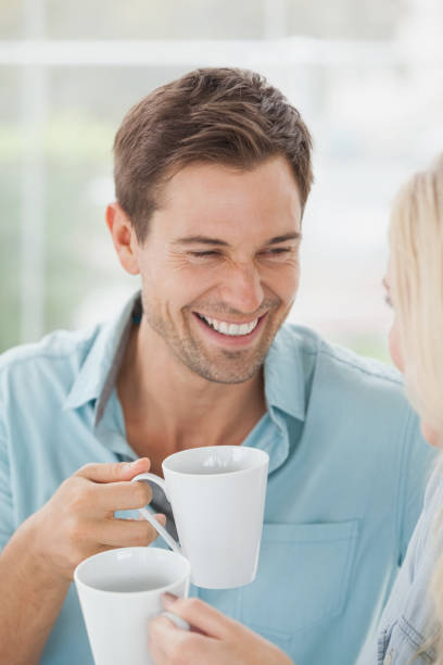 istock Cute couple having coffee together in cafe 692477084