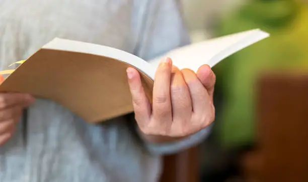 Photo of girl holding book in hand