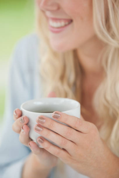 istock Cute blonde holding white mug 692479674