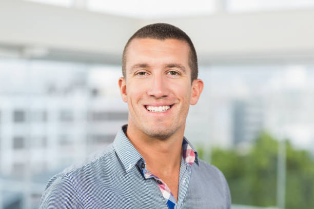 istock Smiling businessman in grey shirt 692486918