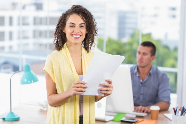 istock Smiling businesswoman holding a notebook 692490158