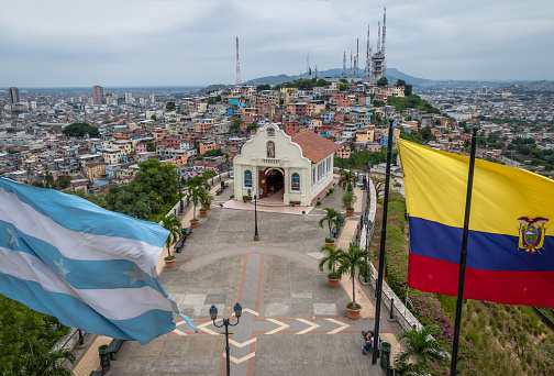 Santa Ana Church on top of Santa Ana hill with Ecuador and city flags - Guayaquil, Ecuador