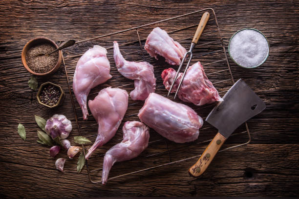 Rabbit. Raw rabbit slices with spices garlic kitchen utensil,fork and butcher. Hunting cuisine. Rabbit. Raw rabbit slices with spices garlic kitchen utensil,fork and butcher. Hunting cuisine. rabbit game meat stock pictures, royalty-free photos & images