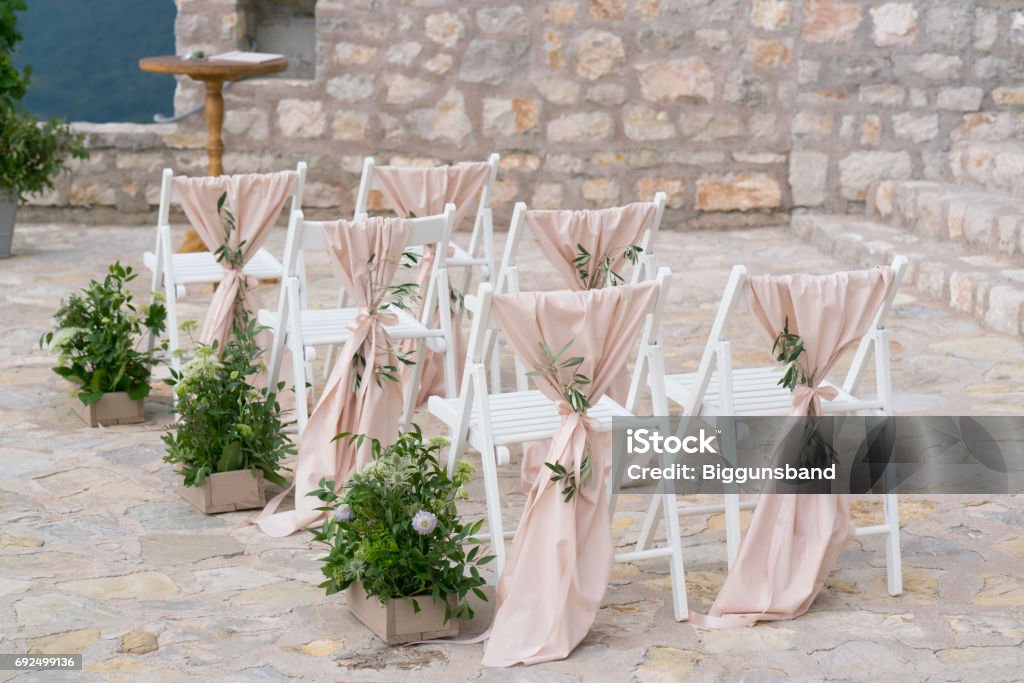decorated chairs at the wedding venue decorated chairs at the venue of the wedding ceremony Wedding Stock Photo