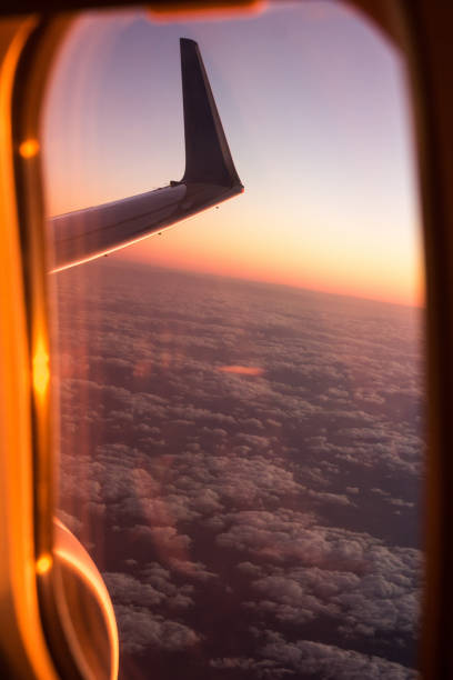 istock cloudscape of window at flying airplane 692499618