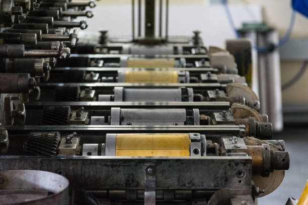 istock Golden Letterpress Cylinders Rustic Vintage Printing Method Metallic Rollers Four Color CMYK Print Closeup Machine Industrial Equipment 692503372