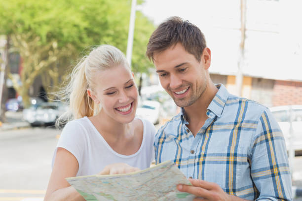 istock Young tourist couple consulting the map 692517244