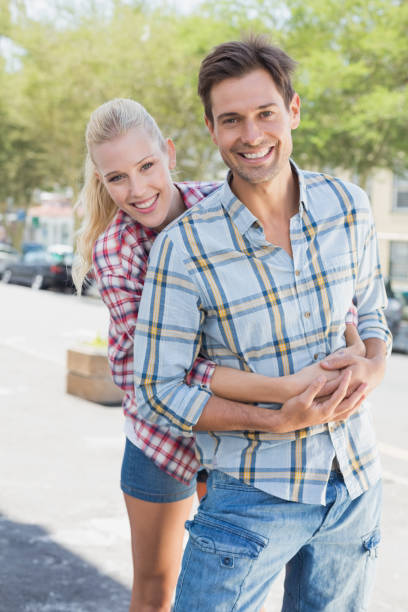 istock Young hip couple hugging and smiling at camera 692525580
