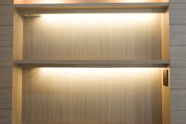 istock Shelves wood wall background with lighting in home 692525610