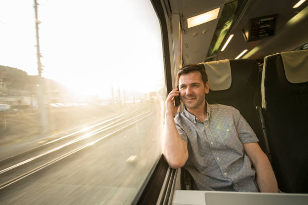 istock Businessman talking at cell phone during traveling by train 692526086