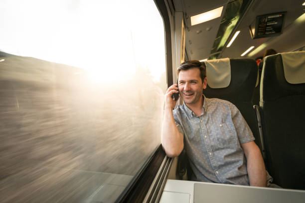 istock Businessman talking at cell phone during traveling by train 692526308