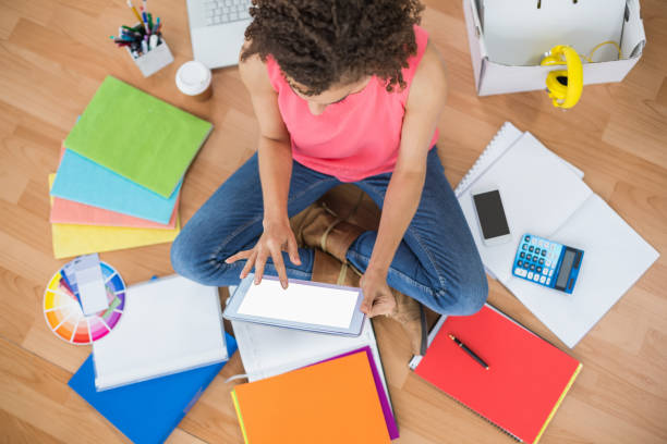 istock Young creative businesswoman scrolling on tablet 692529574