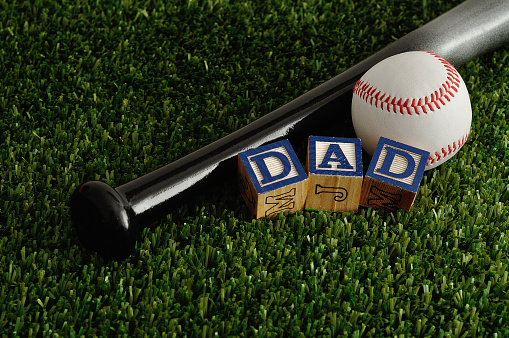 Dad spelled with colorful blocks with a baseball and a bat