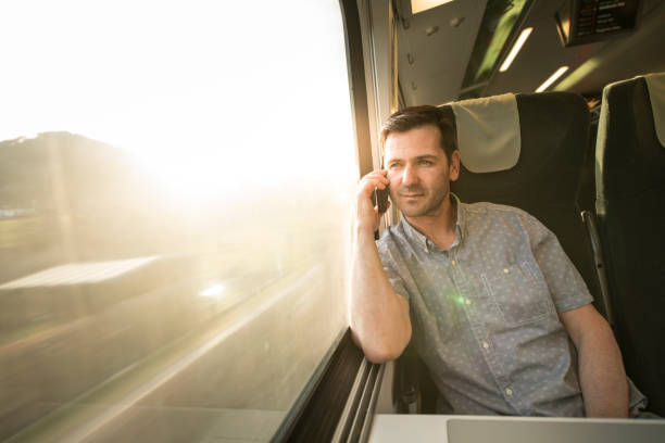 istock Businessman talking at cell phone during traveling by train 692533502