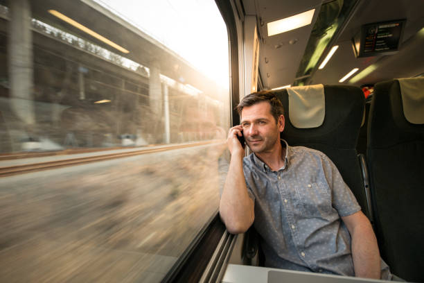 istock Businessman talking at cell phone during traveling by train 692536390