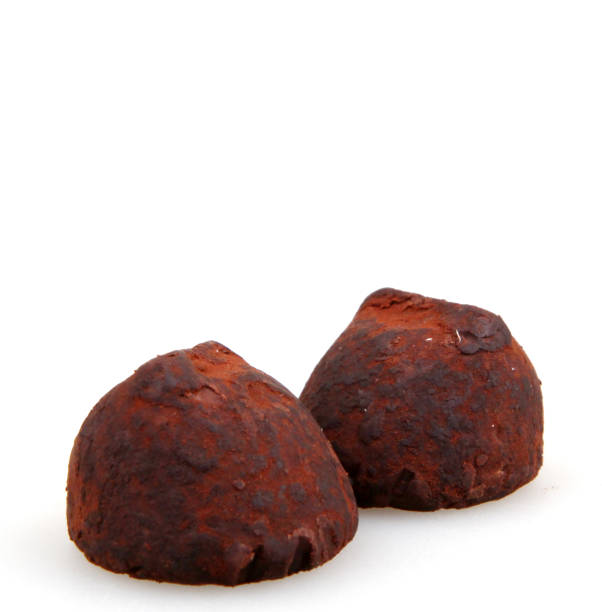istock Chocolate truffles isolated on white background 692537674