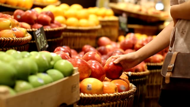 Choosing and buying apples at the store