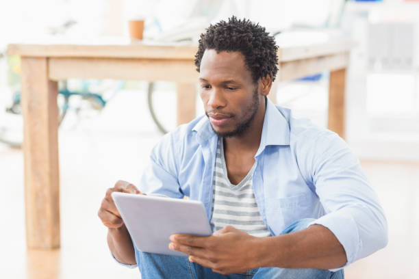 istock Young creative businessman scrolling on the tablet 692542902
