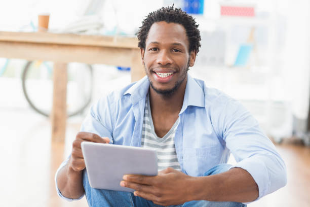 istock Young creative businessman scrolling on the tablet 692544978