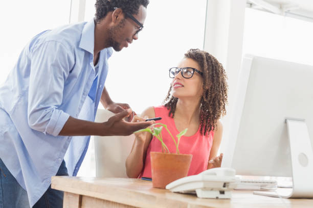 istock Two creative business colleagues talking together 692546456