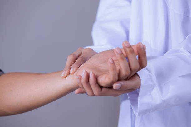 istock Doctor checking the pulse of a patient by hand 692552250