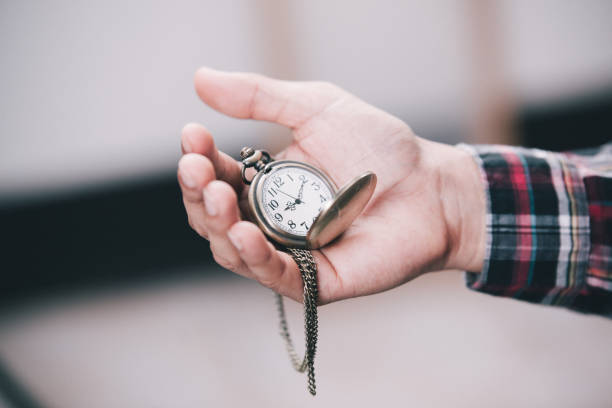 istock Close Up Of Hand Holding Stopwatch against 692552784