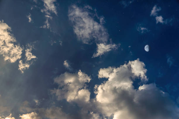 istock yellow sunset with moon and clouds like day and night 692553840