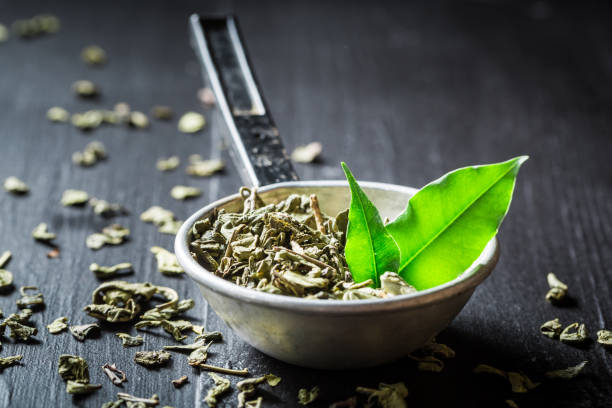 istock Enjoy your green tea in old metal strainer 692556824