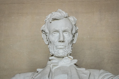 A close-up portrait of Abraham Lincoln at the Lincoln Memorial in Washington DC