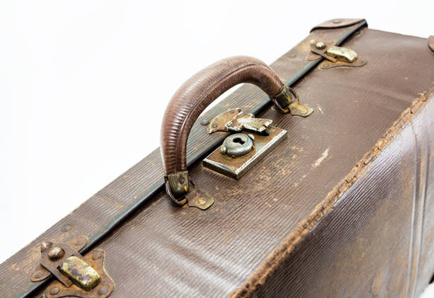 istock A vintage isolated travel bag on a white background. This image can be used to represent traveling or luggage. 692559846