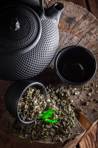 istock Tasty green tea on old wooden stump 692560636