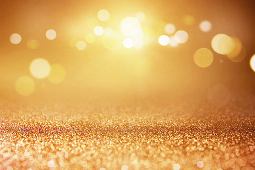Gold glitter lights bokeh abstract background. defocused.