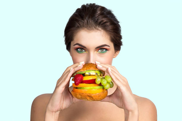 istock Woman eating vegetable hamburger 692578106