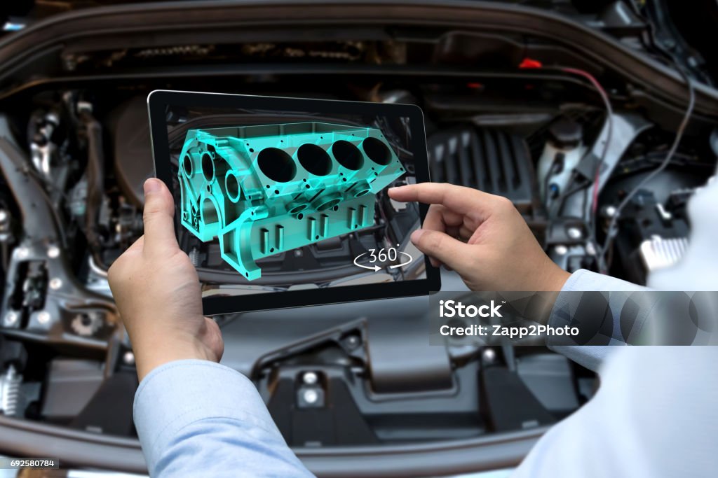 Augmented reality technology and engineering marketing concept. Hand holding tablet with AR service application to rotate 3d rendering of energy block 360 degrees with blur car engine room background Augmented Reality Stock Photo