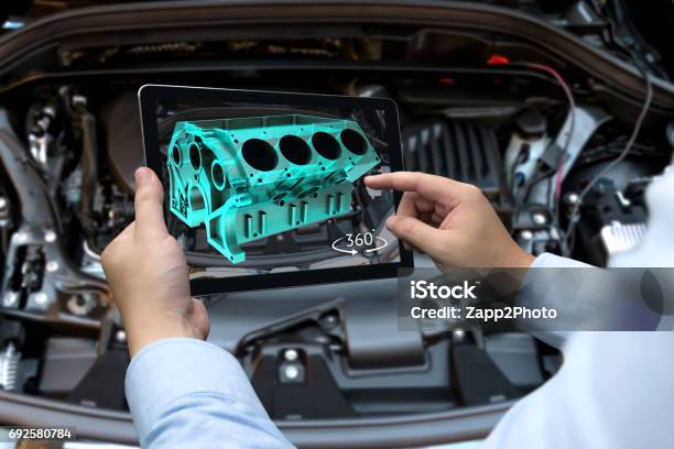 Augmented Reality Technology And Engineering Marketing Concept Hand Holding Tablet With Ar Service Application To Rotate 3d Rendering Of Energy Block 360 Degrees With Blur Car Engine Room Background Stock Photo - Download Image Now