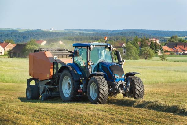 istock Blue tractor on the pasture.. Agricultural work on the farm 692591646