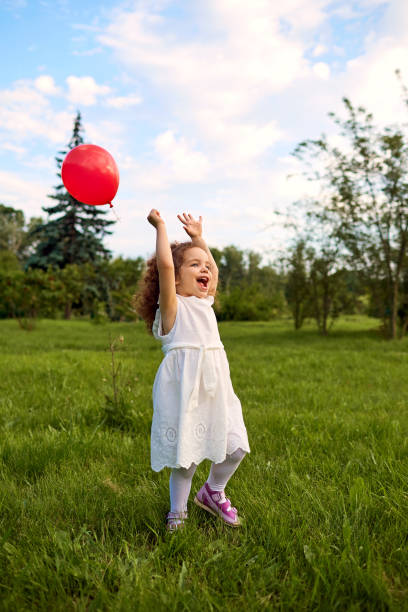 istock Child with an inflatable ball is playing in the park. 692605308