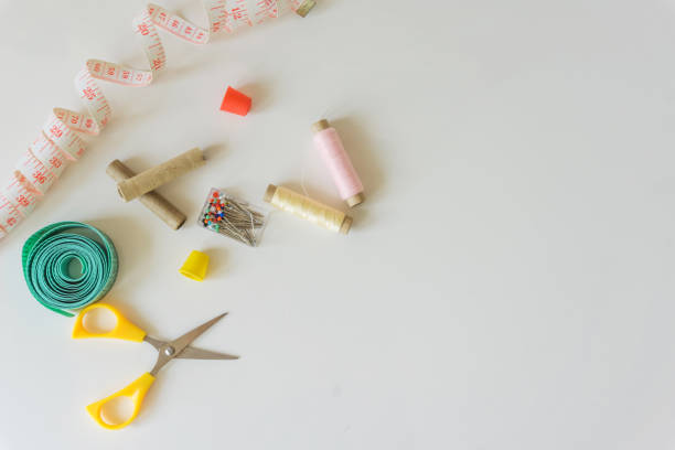 istock Close-up of a sewing set. Tailoring, pins, thimbles and spool with thread in different colors. Copy space. 692608210
