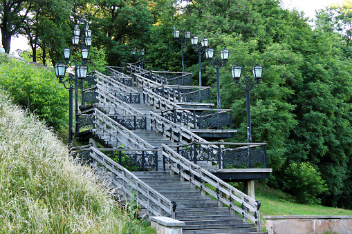 wooden stairs in the city park with lanterns