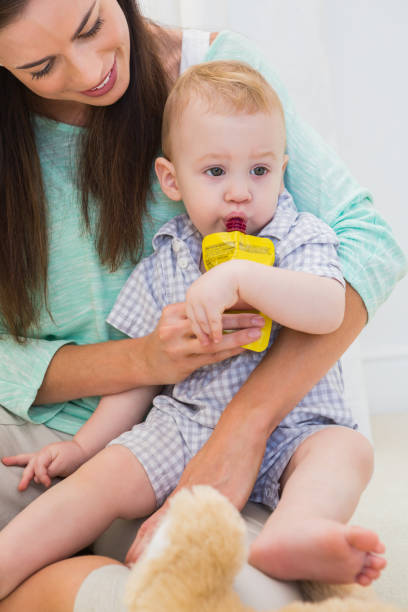 istock Mother giving baby a drink 692609534